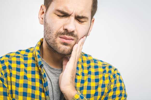 Какие причины могут вызывать болевые ощущения при кисте зуба на нижней челюсти?